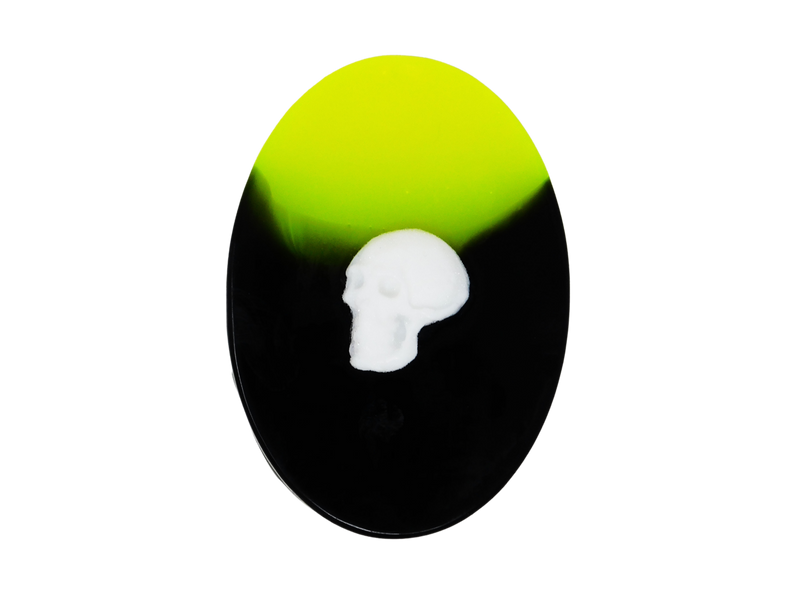 neon yellow and black oval soap with white skull on top