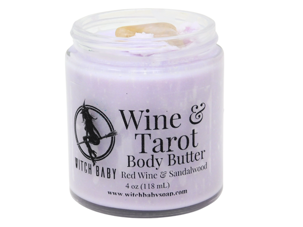 purple body butter packaged in a glass jar with citrine on top and a clear label that reads: wine & tarot body butter, red wine & sandalwood