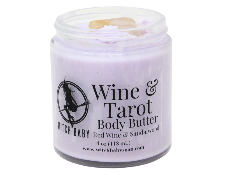 purple body butter packaged in a glass jar with citrine on top and a clear label that reads: wine & tarot body butter, red wine & sandalwood