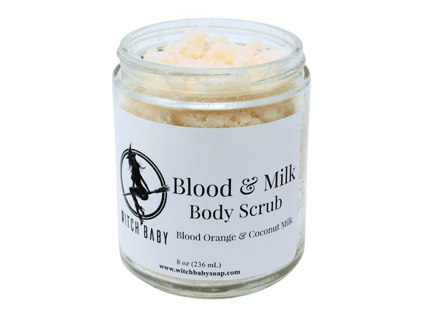 Photo of Blood and Milk body scrub - off white scrub in glass jar with white label that reads: Blood & Milk Body Scrub. Blood Orange & Coconut Milk. 8 oz (236 mL) www.witchbabysoap.com