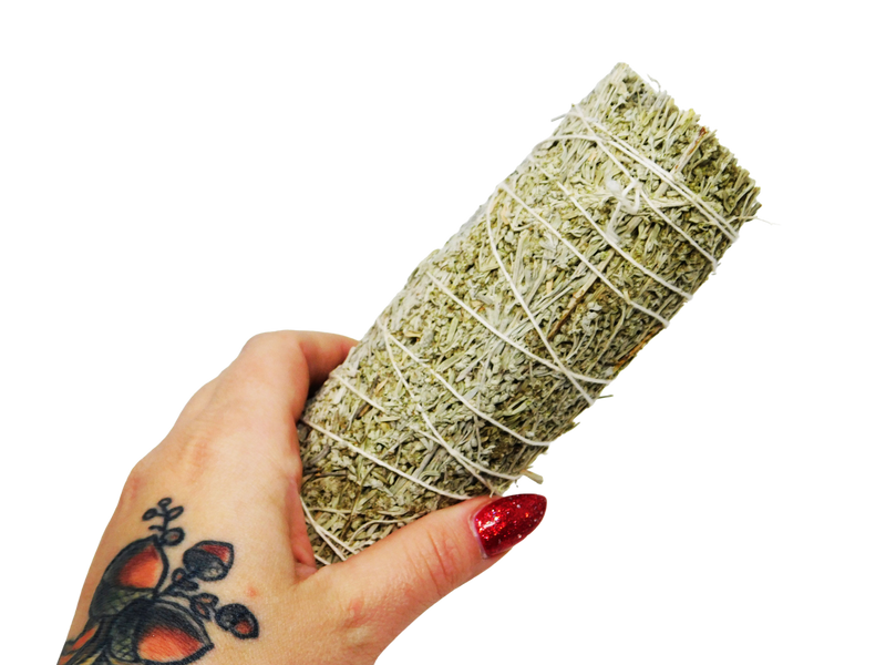 hand holding bundle of blue sage.